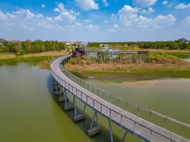 Features a single-family home with a spacious yard in Bridgeland, a master-planned community offering lakes, pools, sidewalks, and green spaces. | Image 37