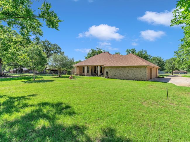 View of yard featuring concrete driveway and an attached garage | Image 35