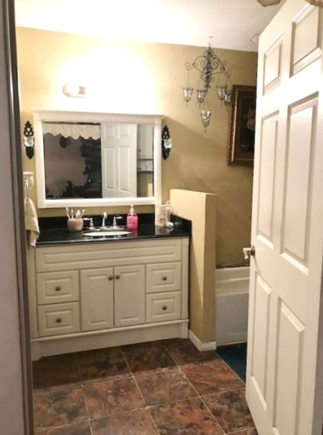 Bathroom with a bathtub and vanity | Image 12