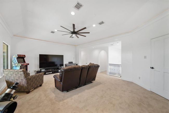 A view of the game room with access to the secondary bedrooms shown in the background. | Image 30