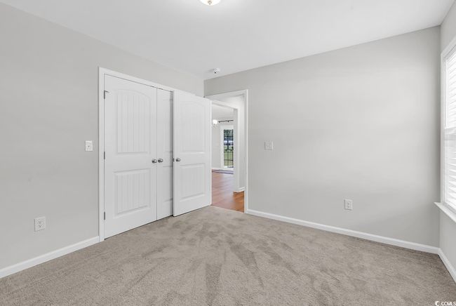 Unfurnished bedroom featuring carpet, multiple windows, a closet, and baseboards | Image 19