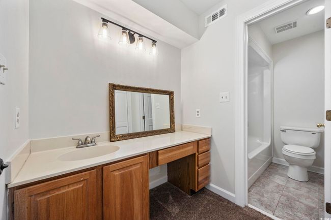 Full bath with vanity, toilet, baseboards, and shower / bath combination | Image 32