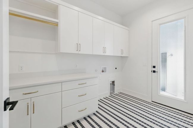 Clothes washing area featuring cabinet space, hookup for an electric dryer, hookup for a washing machine, and gas dryer hookup | Image 12