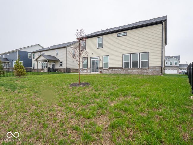 rear view of house with fence and a lawn | Image 54