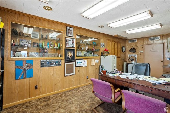 Carpeted office with visible vents and wood walls | Image 18