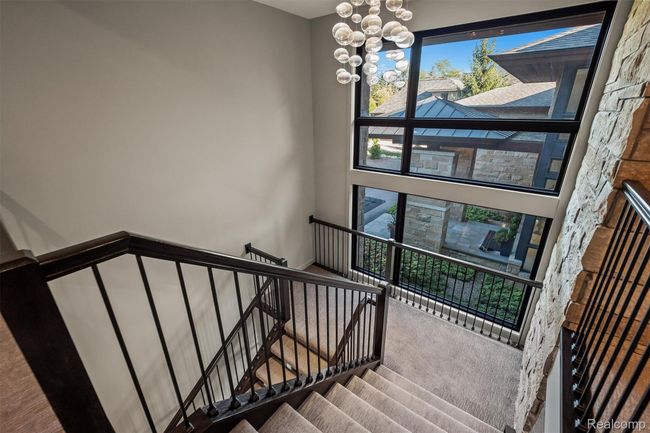 Stairs featuring carpet floors and a chandelier | Image 17
