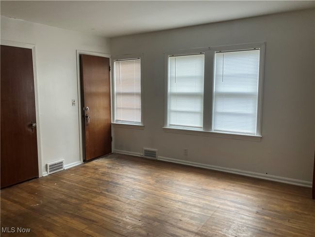 Spare room featuring visible vents, baseboards, and wood-type flooring | Image 10