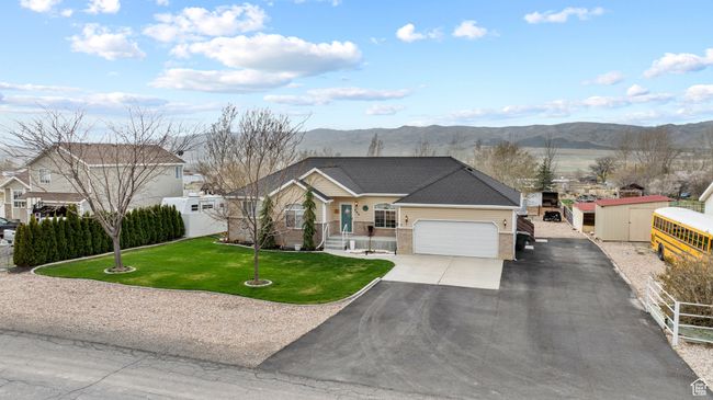 View of front of property with brick siding, a front yard, driveway, and a mountain view | Image 40