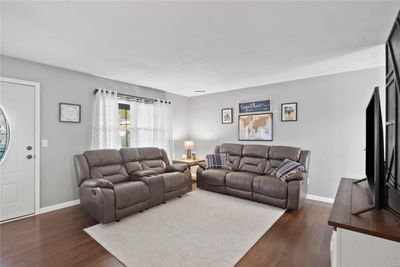 Living room with dark wood-type flooring | Image 3