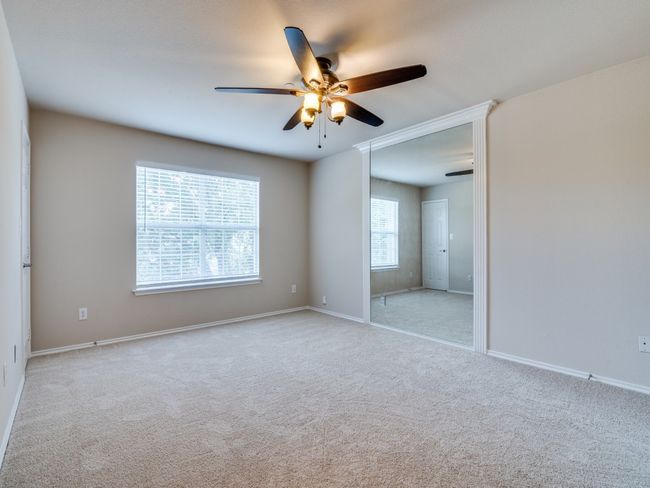 Carpeted spare room with ceiling fan and baseboards | Image 10
