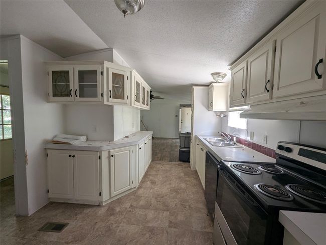 Galley style kitchen with lots of cabinet space | Image 4
