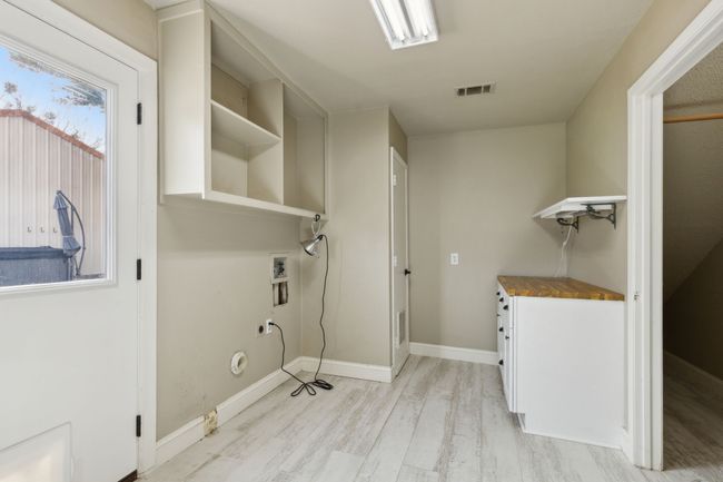 Laundry room featuring visible vents, washer hookup, laundry area, light wood-style flooring, and electric dryer hookup | Image 15