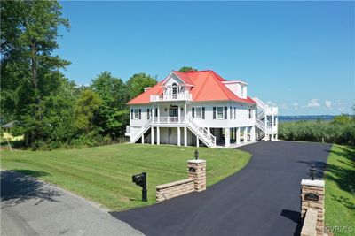 Large paved driveway with 3 covered parking spots on a double lot | Image 2