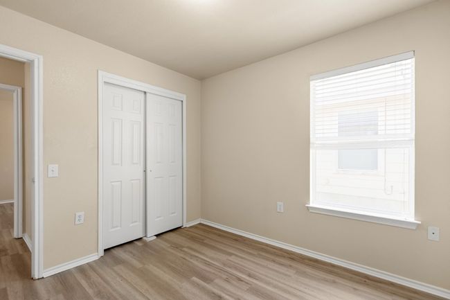 Unfurnished bedroom with light wood finished floors and a closet | Image 24