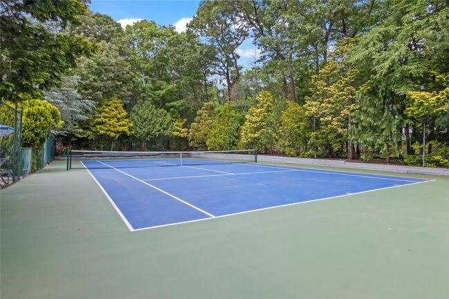 View of tennis court featuring basketball hoop | Image 28
