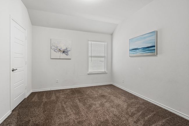 Bedroom #2 on second floor with dark colored carpet, baseboards, and vaulted ceiling, walk in closets | Image 24