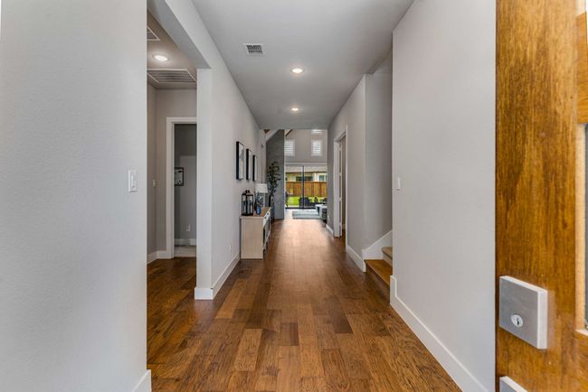 Entry hall leading to bedrooms and living spaces with gorgeous oak flooring! | Image 12