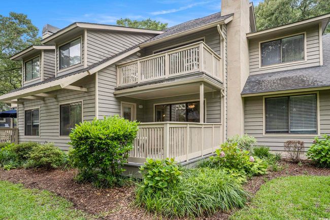View of back of condo balcony and a chimney | Image 23