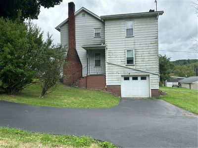 side of structure showing integral garage door | Image 3