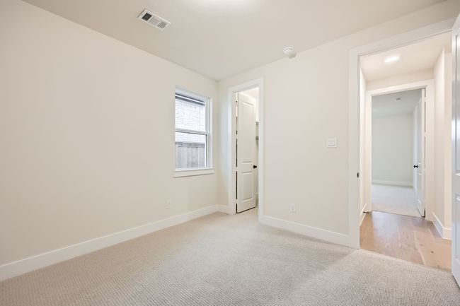 Unfurnished bedroom featuring baseboards, light colored carpet, and visible vents | Image 22
