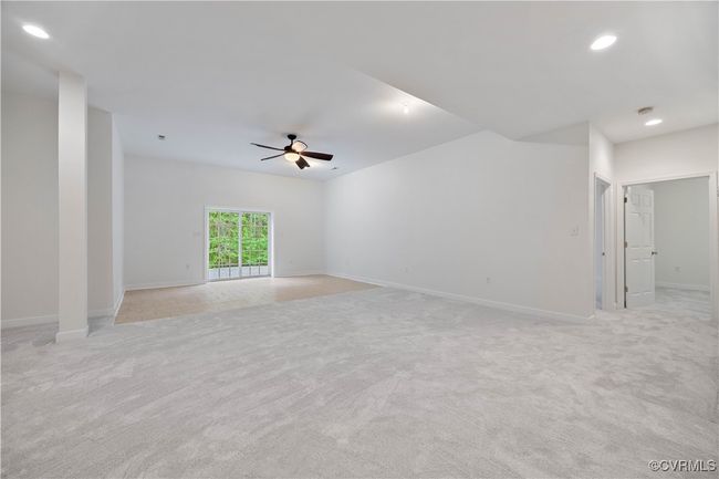 Spare room featuring baseboards, recessed lighting, ceiling fan, and light colored carpet, leads to a beautiful patio | Image 45