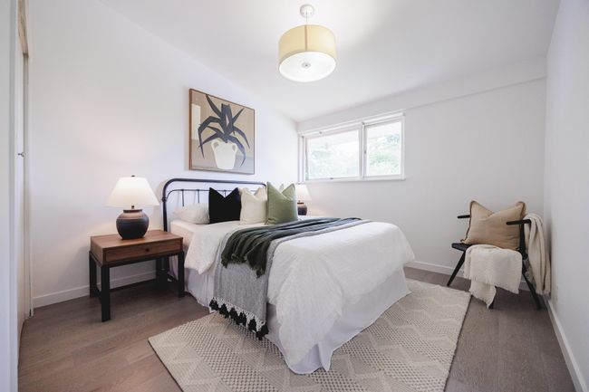 Bedroom featuring wood finished floors and lofted ceiling | Image 15