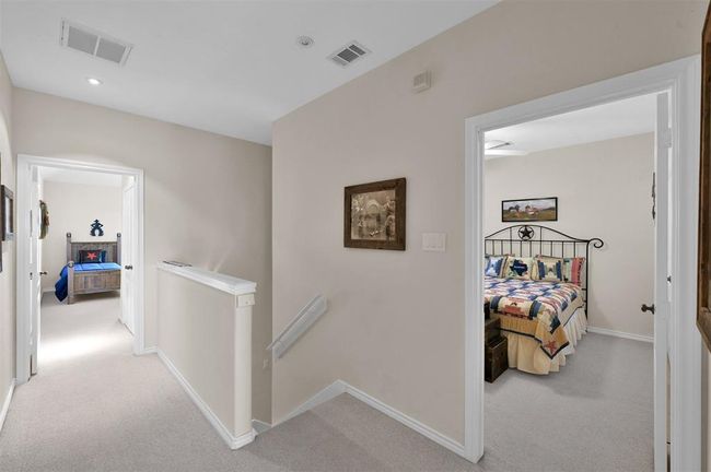Two spacious secondary bedrooms with a shared bath are also located upstairs. | Image 18