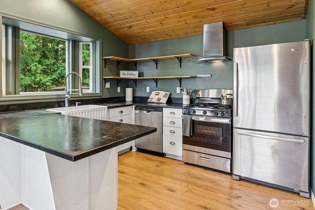 Charming kitchen with stainless steel appliances, farm house sink and soapstone countertops | Image 4