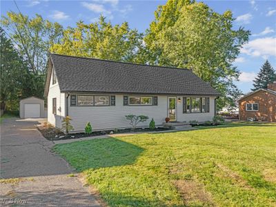 Single story home with an outbuilding, a garage, and a front yard | Image 1