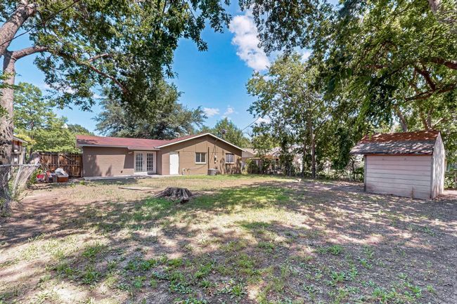 Fenced backyard featuring french doors and a shed | Image 30