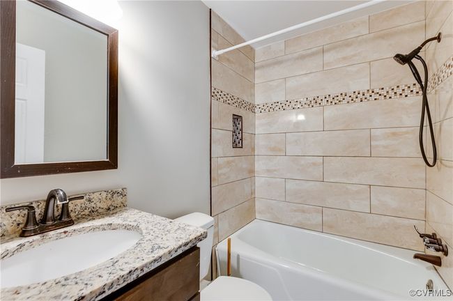 Bathroom with vanity and bathtub / shower combination | Image 13
