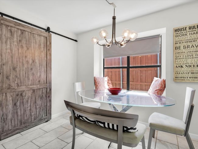 Dining space featuring a barn door and a chandelier | Image 8