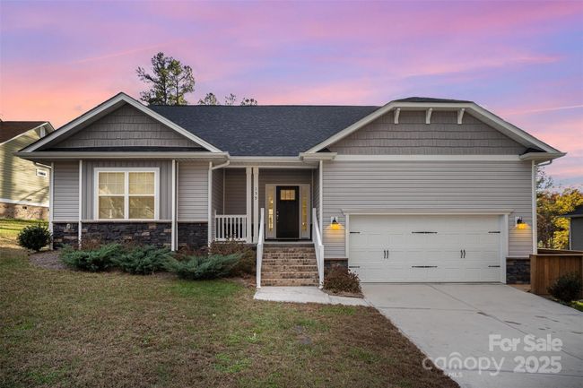 Twlight picture of the front of the home. Home has dawn to dusk automatic garage lighting. | Image 36