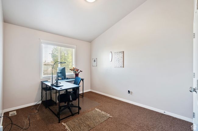 Carpeted home office featuring baseboards and lofted ceiling | Image 22