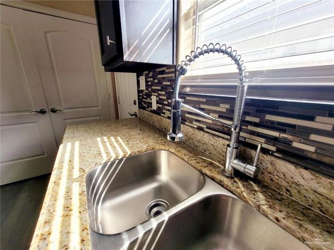 Kitchen view of backsplash and light stone countertops | Image 8
