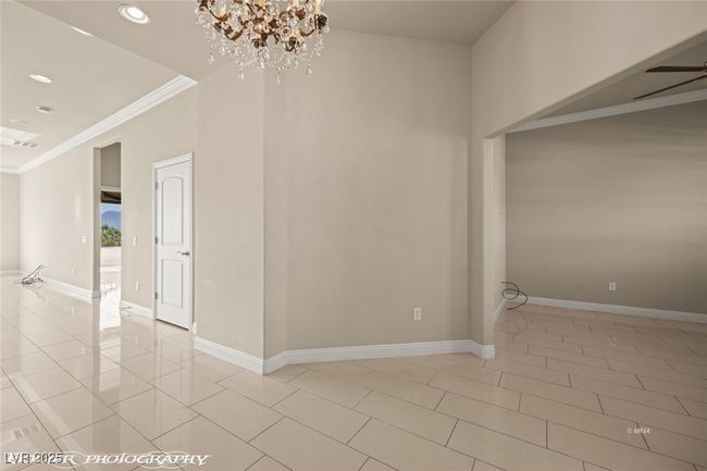 Empty room featuring ornamental molding, visible vents, recessed lighting, baseboards, and a notable chandelier | Image 7
