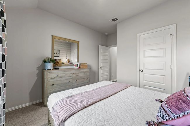 Carpeted bedroom with baseboards and vaulted ceiling | Image 8