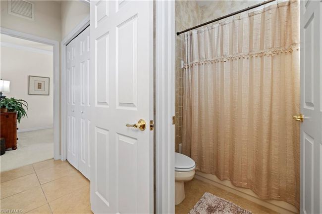 Bathroom #2 with visible vents, tile patterned flooring, shower / bath combination with curtain, and toilet | Image 11