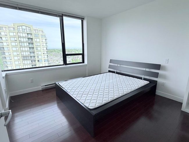 Bedroom with baseboards and wood finished floors | Image 17