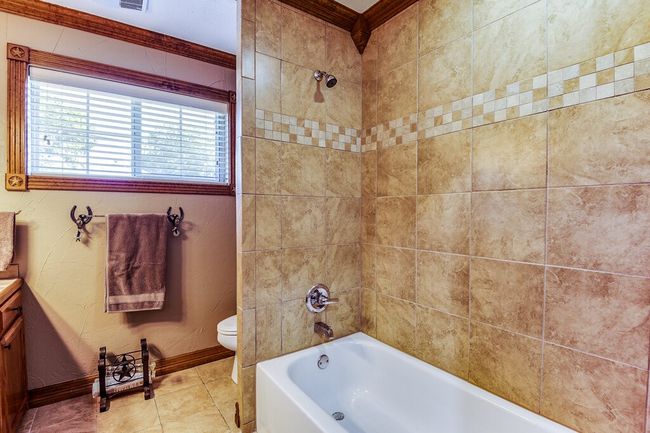 Full bathroom featuring vanity, tile patterned floors, and shower / bathtub combination | Image 20