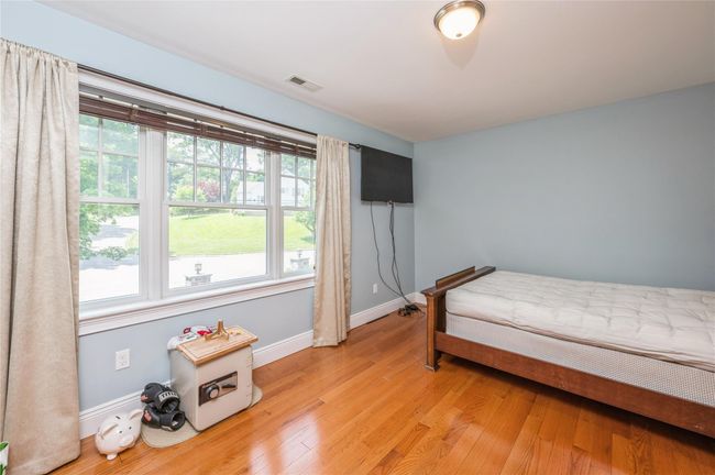 Bedroom featuring multiple windows and light wood finished floors | Image 12