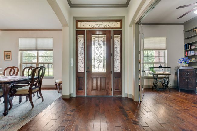 Foyer with dark wood-style floors, ceiling fan, and crown molding | Image 7