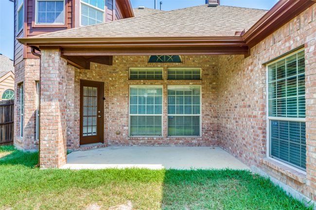 View of exterior entry with a shingled roof, brick siding, and a patio​​‌​​​​‌​​‌‌​‌‌​​​‌‌​​‌‌​‌​​​​​‌ area | Image 33