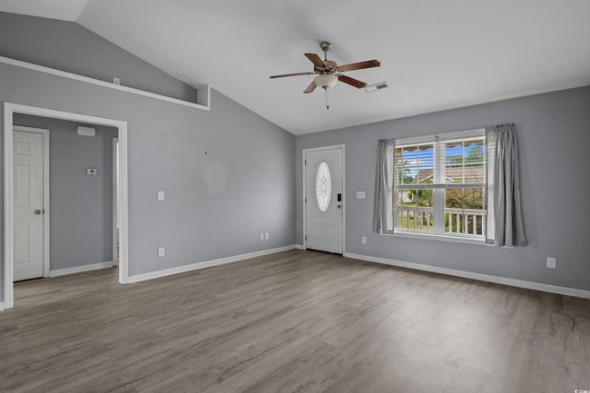 Foyer with lofted ceiling, ceiling fan, wood finished floors, and baseboards | Image 14