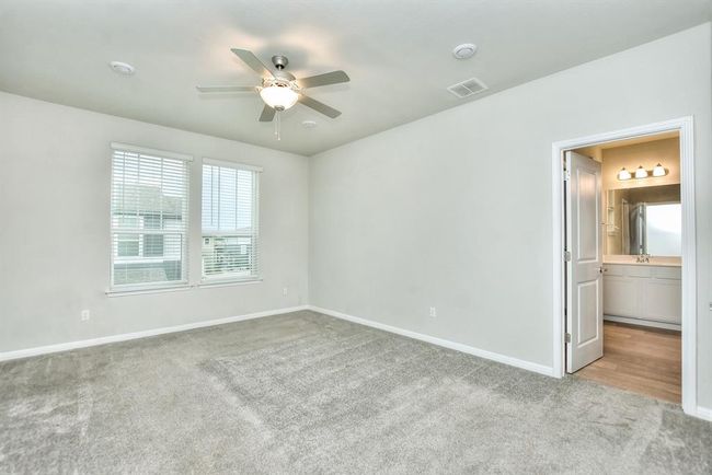 Unfurnished bedroom with carpet and a ceiling fan | Image 14