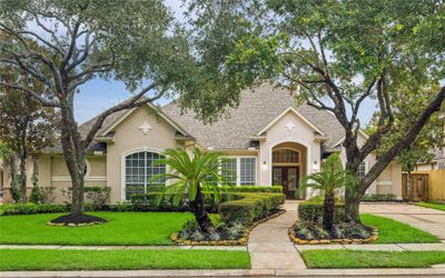 Welcome to 12910 Silent Shore, a move-in ready single-story in desirable Lakes on Eldridge! The front exterior exudes curb appeal with well-maintained landscaping and charming architecture. A welcoming entrance invites you into this desirable single story. | Image 1