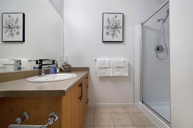 Full bath with baseboards, vanity, tile patterned floors, and tiled shower | Image 19