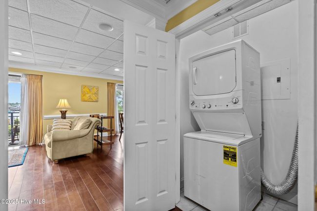 GE: Washer/Dryer stacked combo laundry center off hallway | Image 38