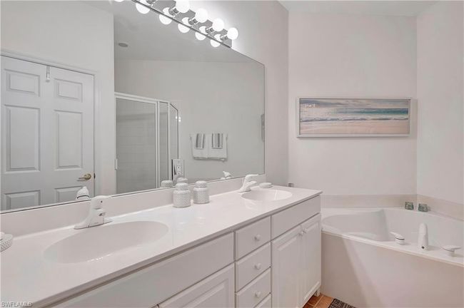 Master Bathroom featuring shower with separate bathtub and vanity | Image 16