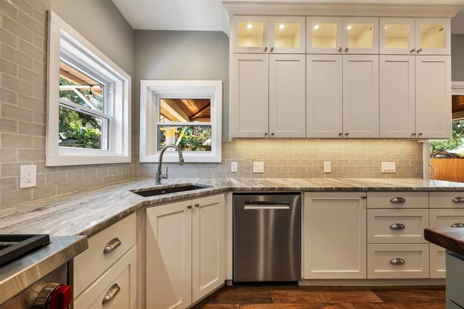 Kitchen featuring stainless steel dishwasher, healthy amount of natural light, and decorative backsplash | Image 12